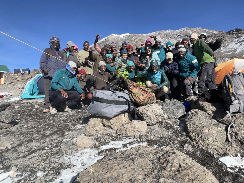 The crew having fun with hikers on Mt. Kilimanjaro