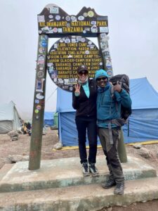 A woman and her guide on the Lemosho Route trek on Mt. Kilimanjaro.