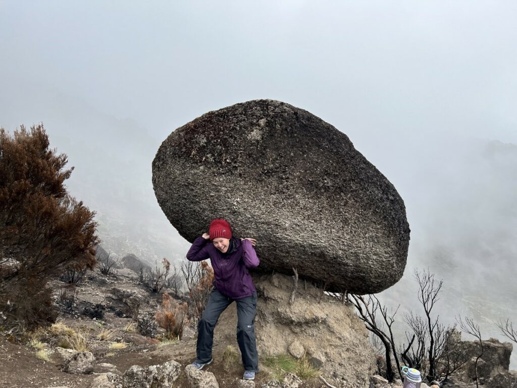Woman posing like she is holding up a rock