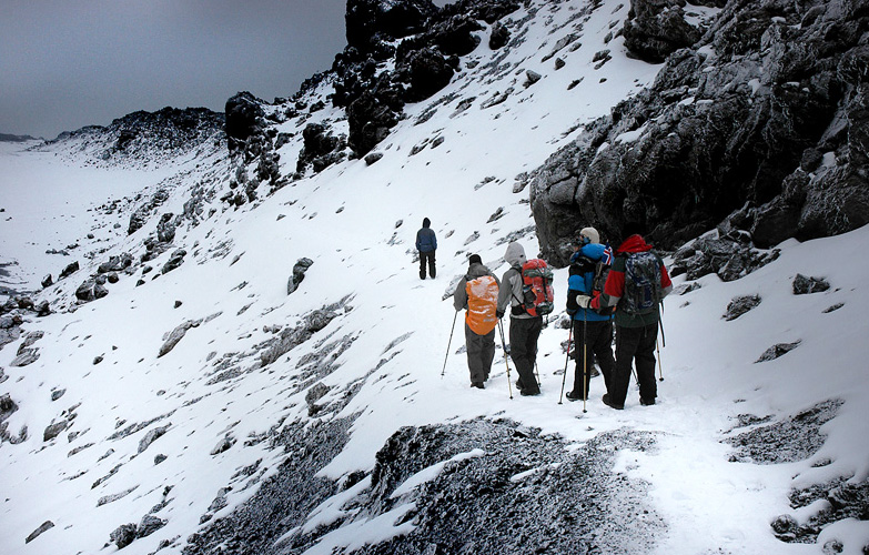 Climbers hiking on a snowy trail on Mt. Kilimanjaro.